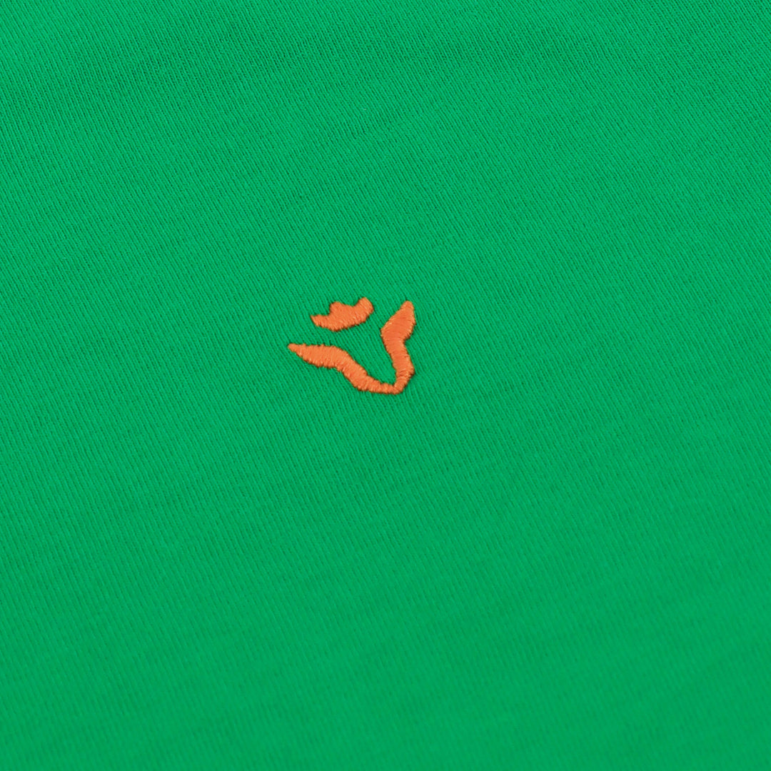 Close-up of Dare Wolf logo on green round neck t-shirt