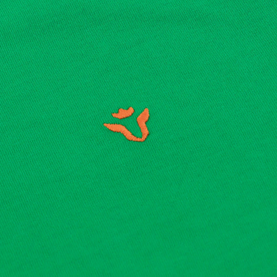 Close-up of Dare Wolf logo on green round neck t-shirt