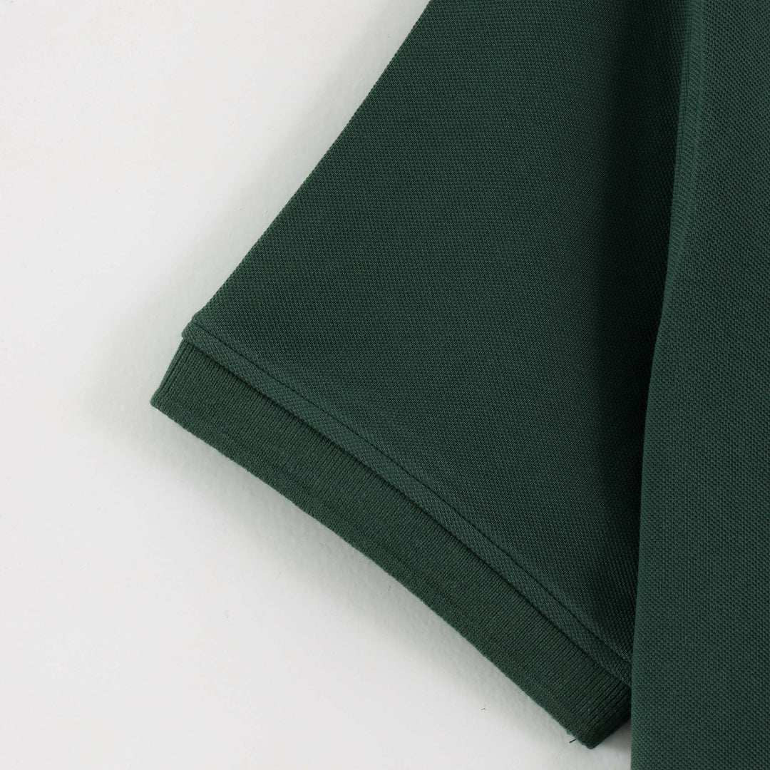 Close-up detail of Dare Wolf dark green polo t-shirt sleeve