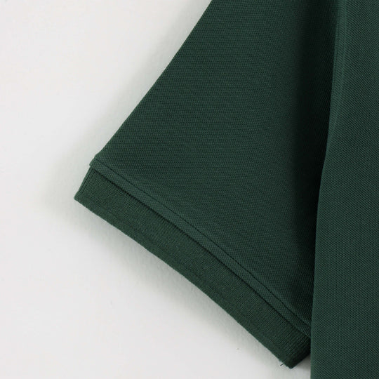 Close-up detail of Dare Wolf dark green polo t-shirt sleeve