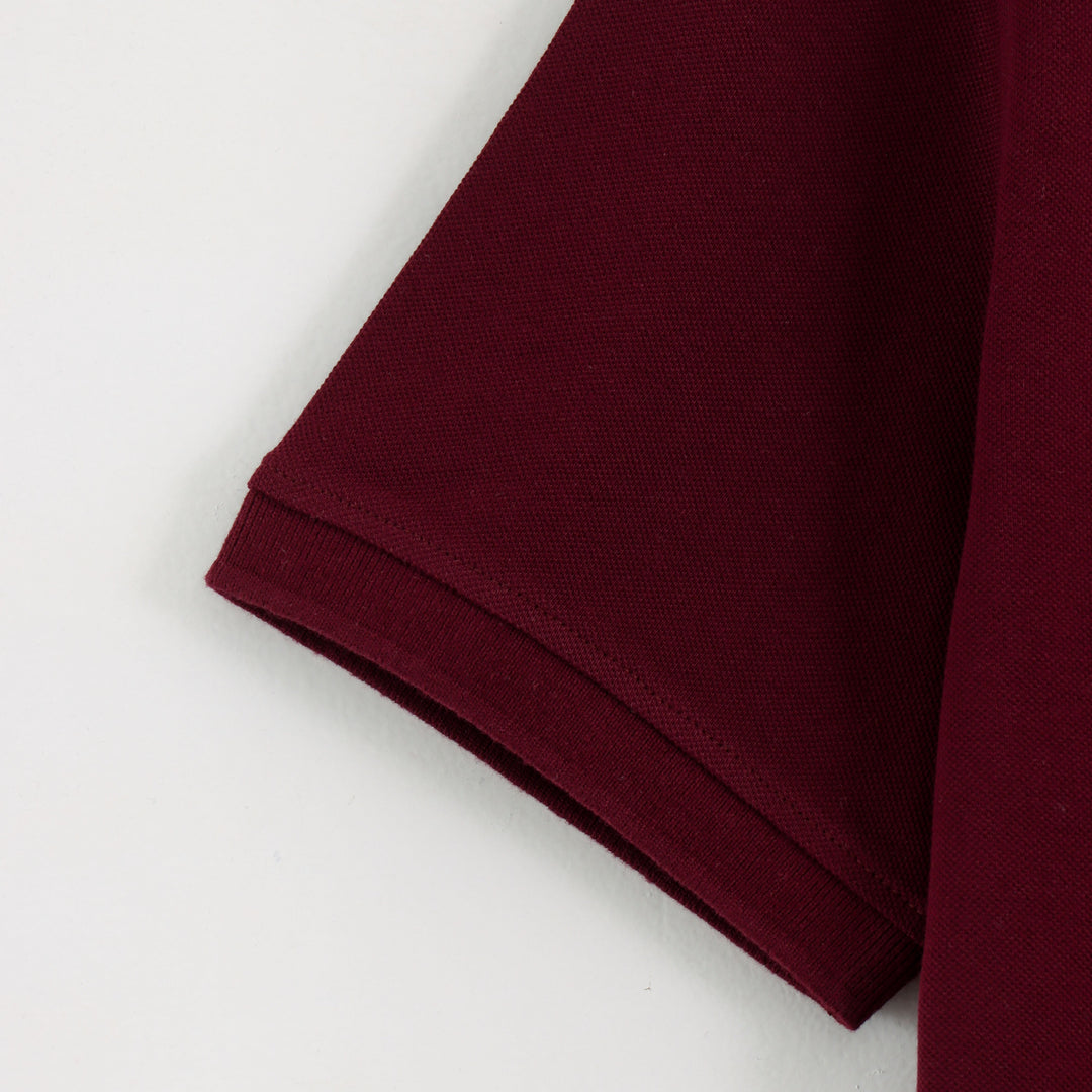 Close-up detail of Dare Wolf maroon polo t-shirt sleeve