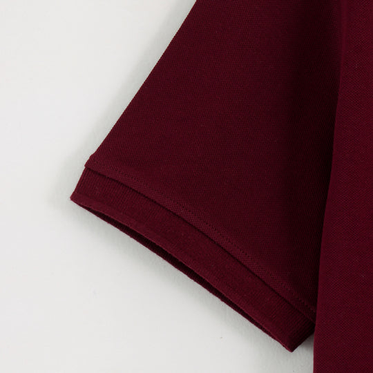 Close-up detail of Dare Wolf maroon polo t-shirt sleeve