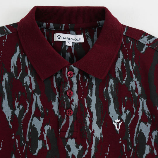 Close-up detail of Dare Wolf maroon abstract polo t-shirt sleeve