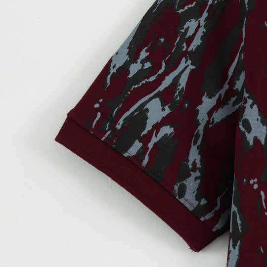 Close-up detail of Dare Wolf maroon abstract polo t-shirt fabric texture
